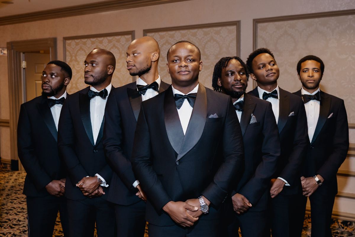 The crew looking away, one man looking straight at the camera