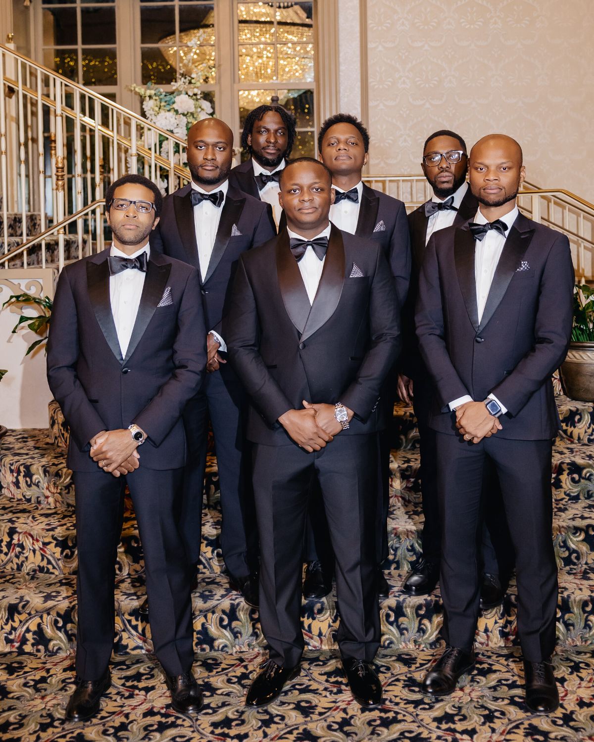 The crew in formation on the staircase, serious faces